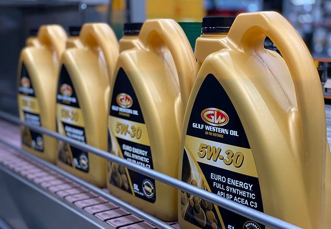 A Row of Bottles of Oil Are Lined up On a Shelf — Wades Distributors In Garbutt, QLD