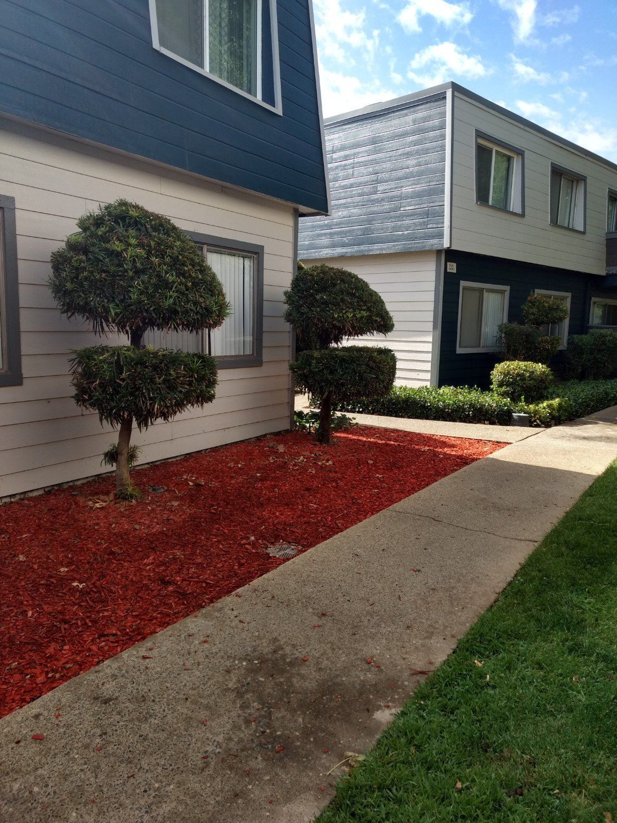 Walkway next to courtyard running in front  of two buildings