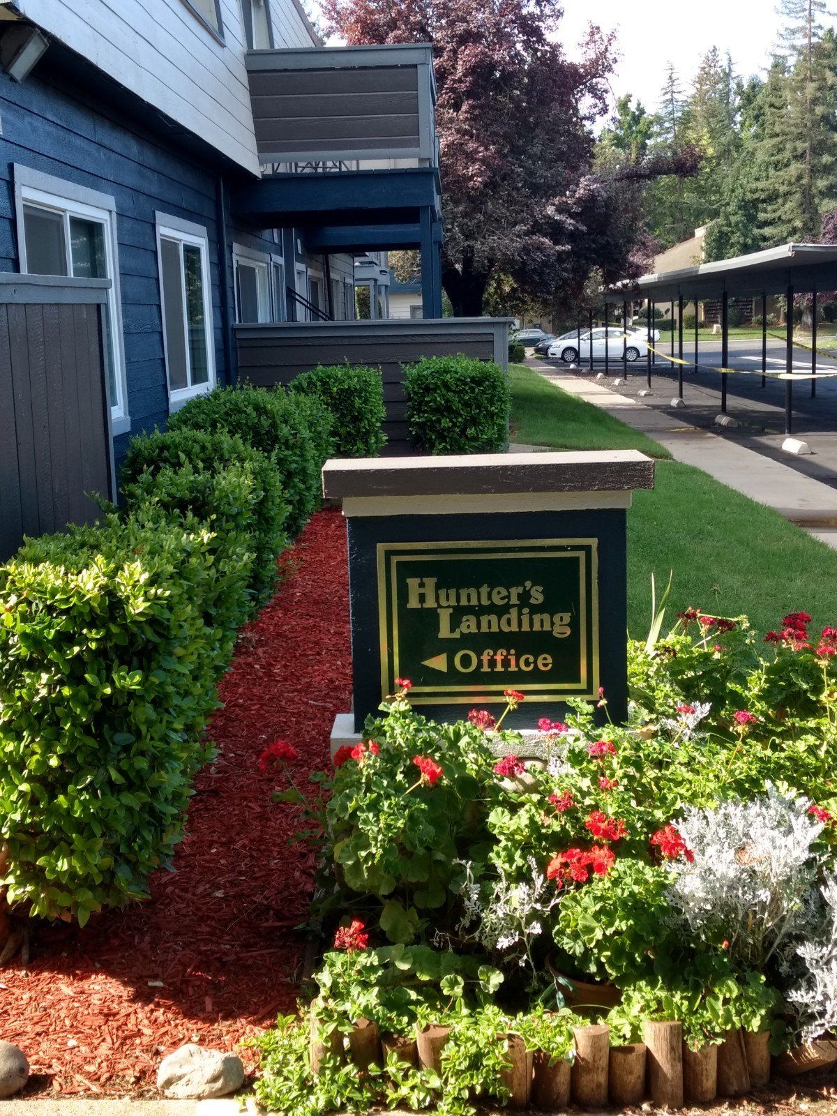 Hunters Landing Sign next to abundant plantings