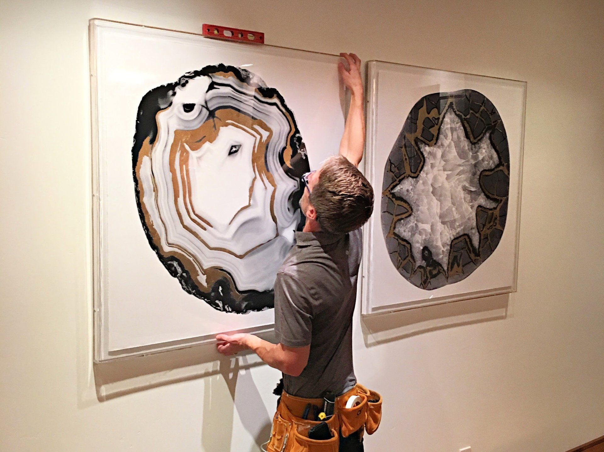 Art advisory, placement, and hanging services provided in a client's home by Anchor Art experts