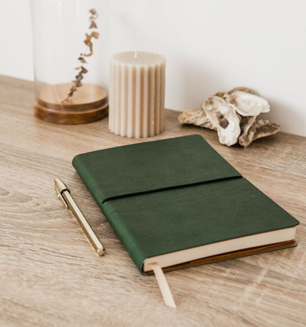 A man and a woman are sitting on a couch looking at a laptop computer.