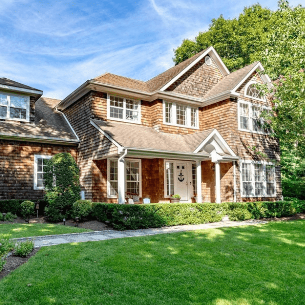 A large house with a lush green lawn in front of it