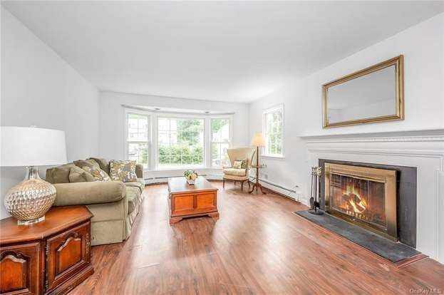 A living room with hardwood floors and a fireplace.