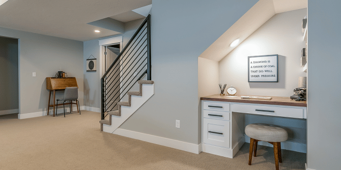 There is a desk under the stairs in the basement.