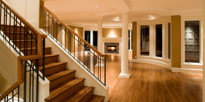 A wooden staircase in a house with a metal railing