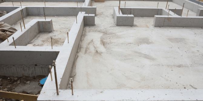 A concrete base for a house is being built.