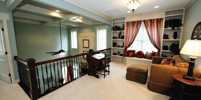 A living room with a staircase leading to the second floor