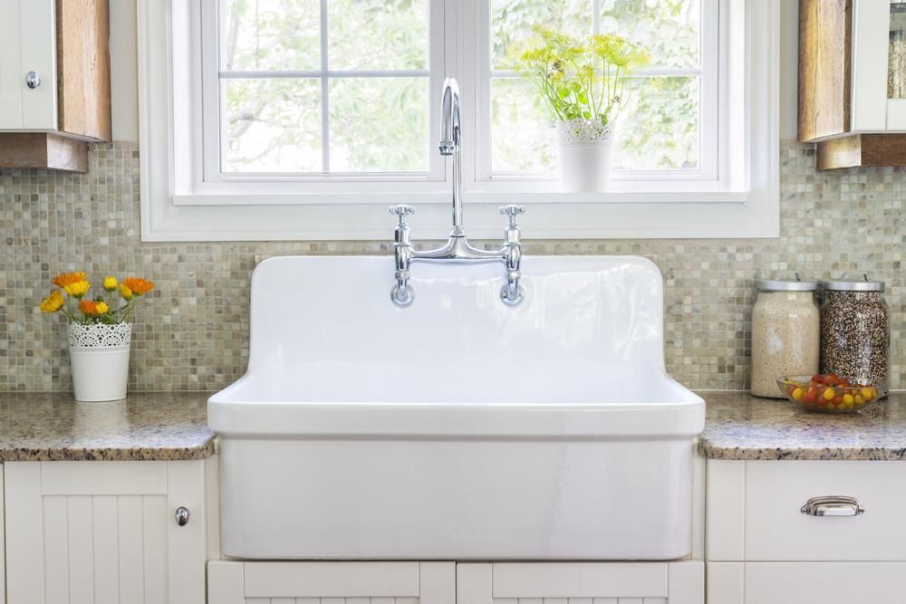 Farmhouse kitchen with classic white porcelain apron-front sink.