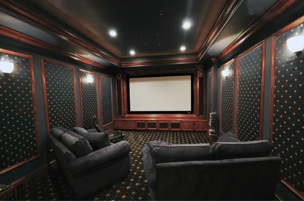 A home theater with a large screen and a couch.