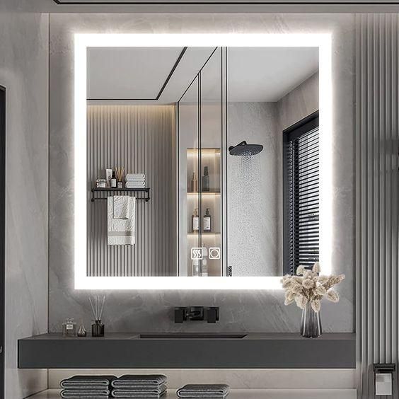 A bathroom with a large mirror and a sink.