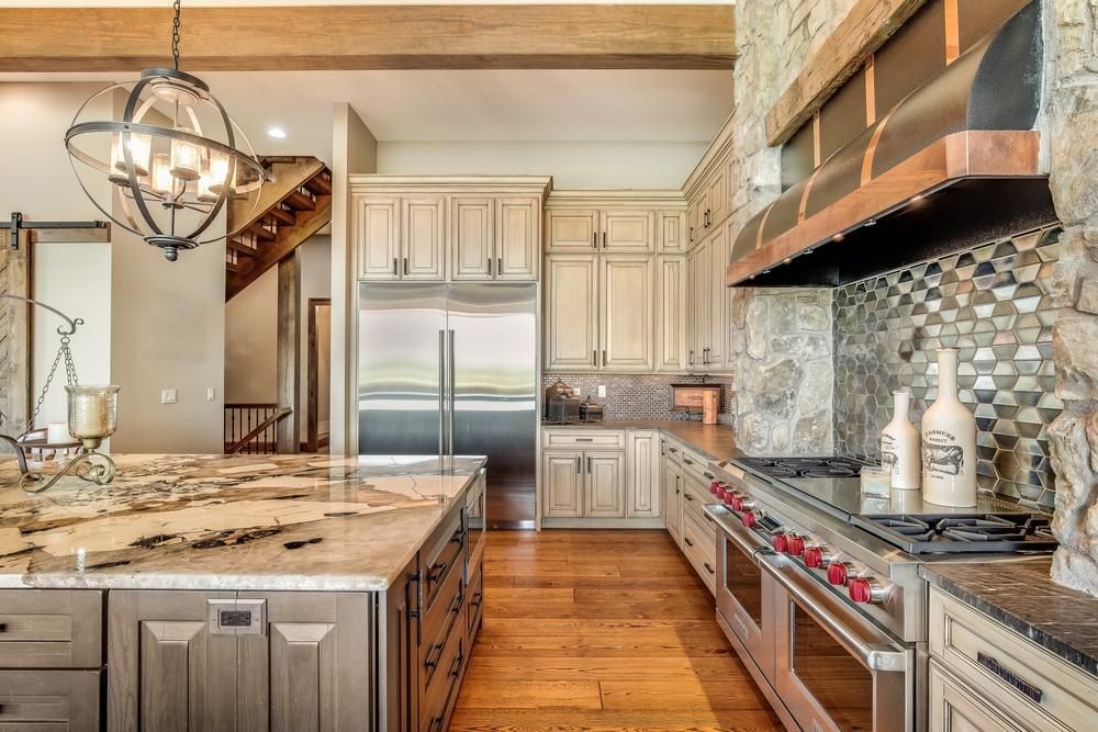 Farmhouse style kitchen remodel using natural stone materials. View 2 of 3.