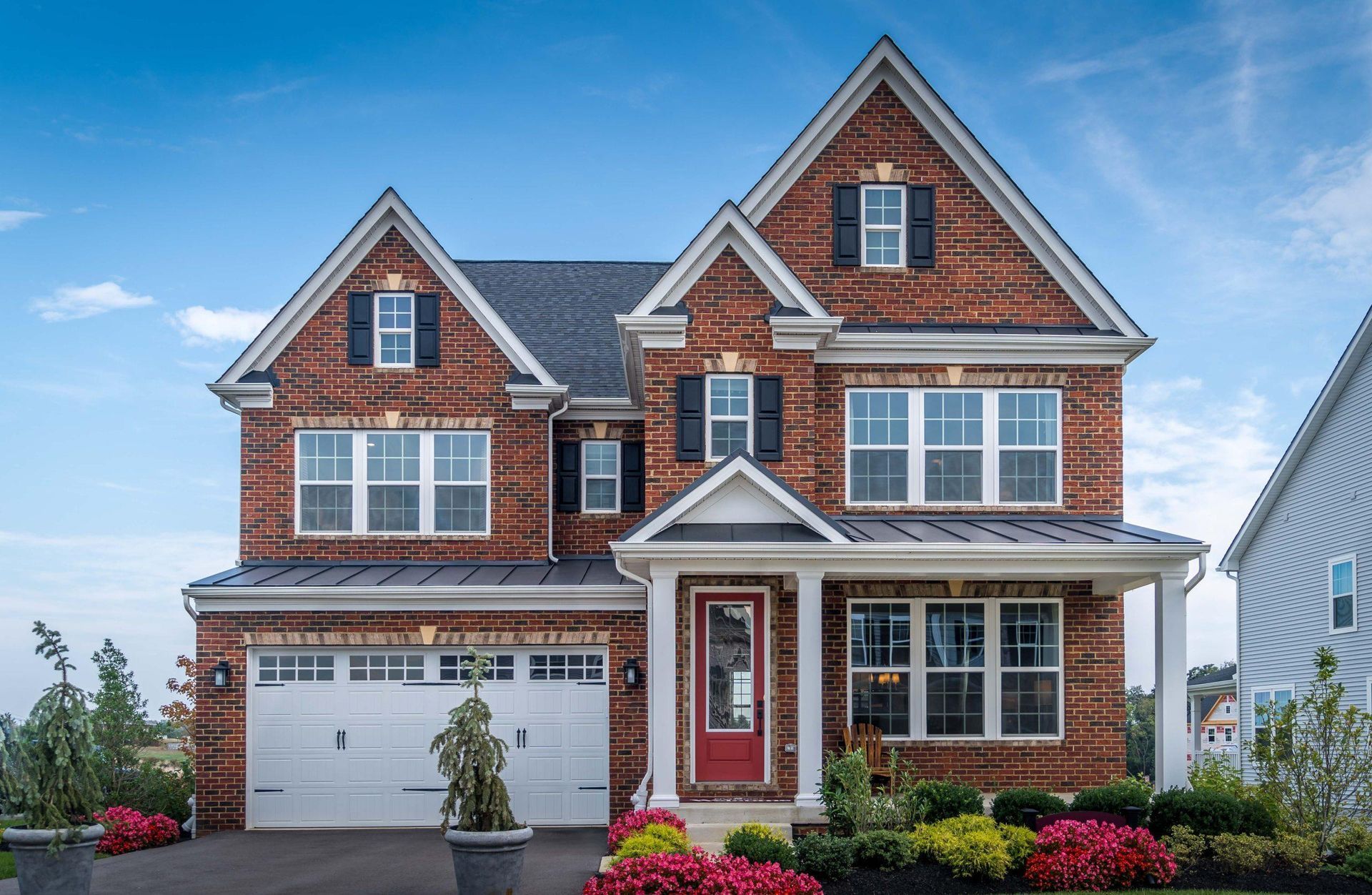 luxury colonial style house with brick siding