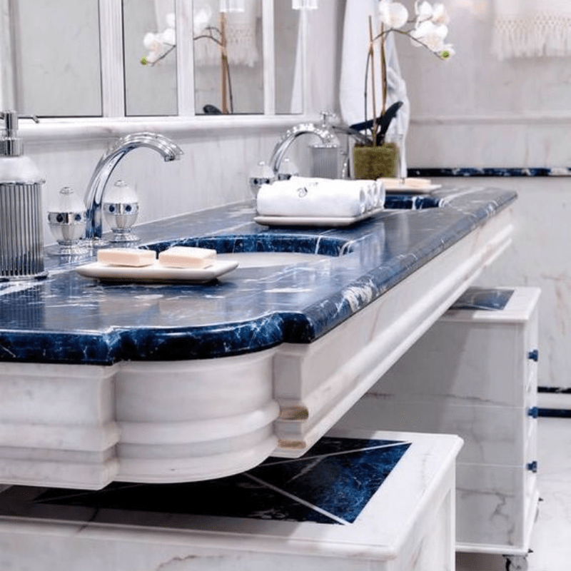 A bathroom with two sinks and a blue counter top