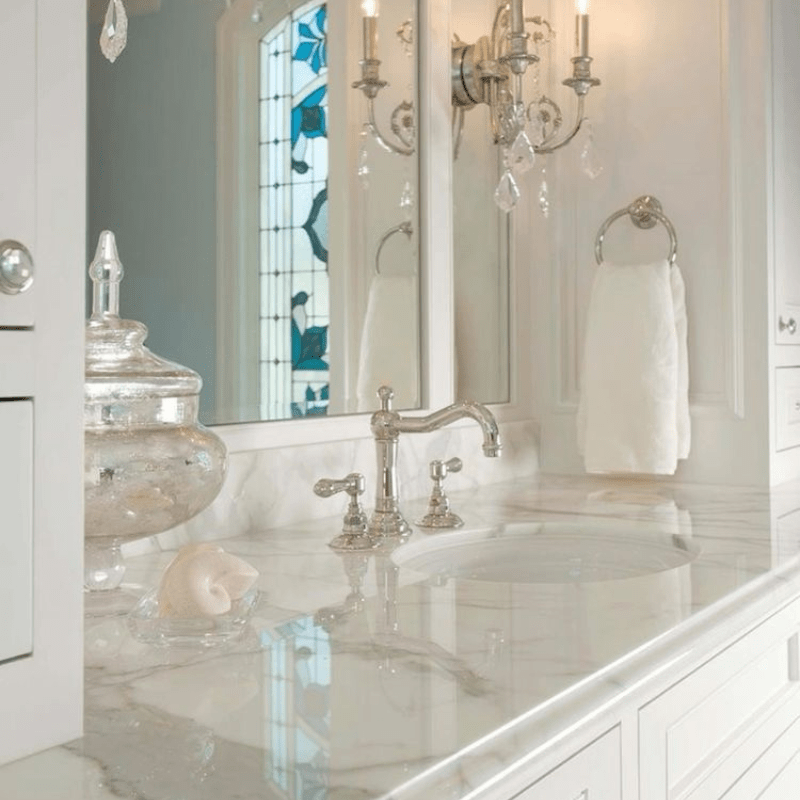 A bathroom with two sinks and a large mirror