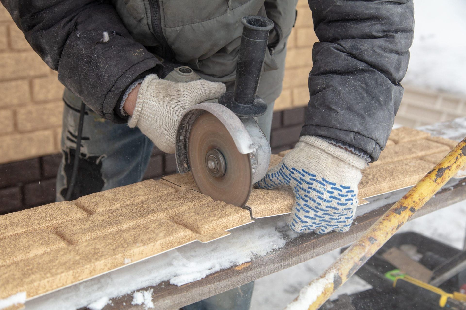 masonry contractor installing brick siding