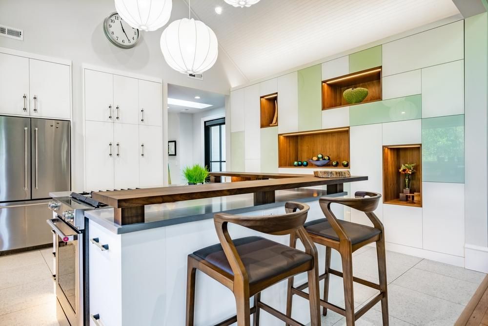 Modern farmhouse style kitchen with white laminate cabinets and stainless steel appliances.