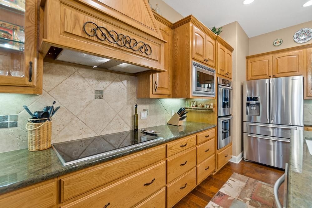 Country farmhouse style wood cabinetry, hood and base cabinets.