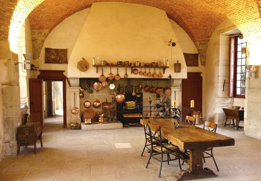 A large room with a table and chairs and a fireplace