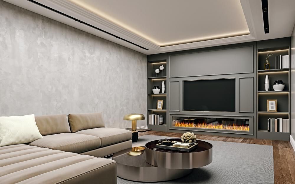 A living room with a couch , coffee table , television and fireplace.