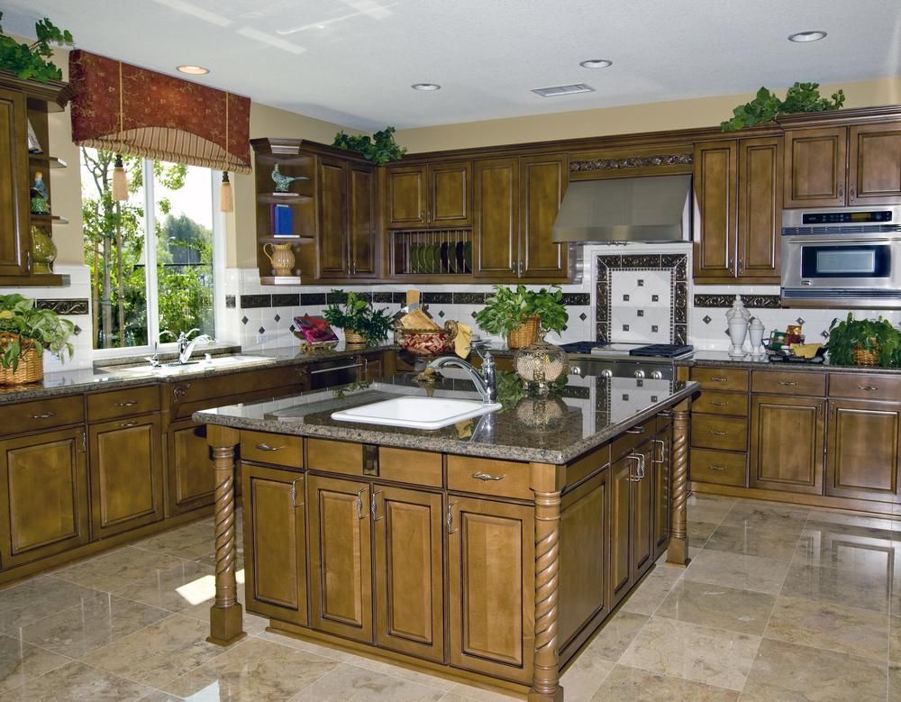 A kitchen with wooden cabinets and granite counter tops