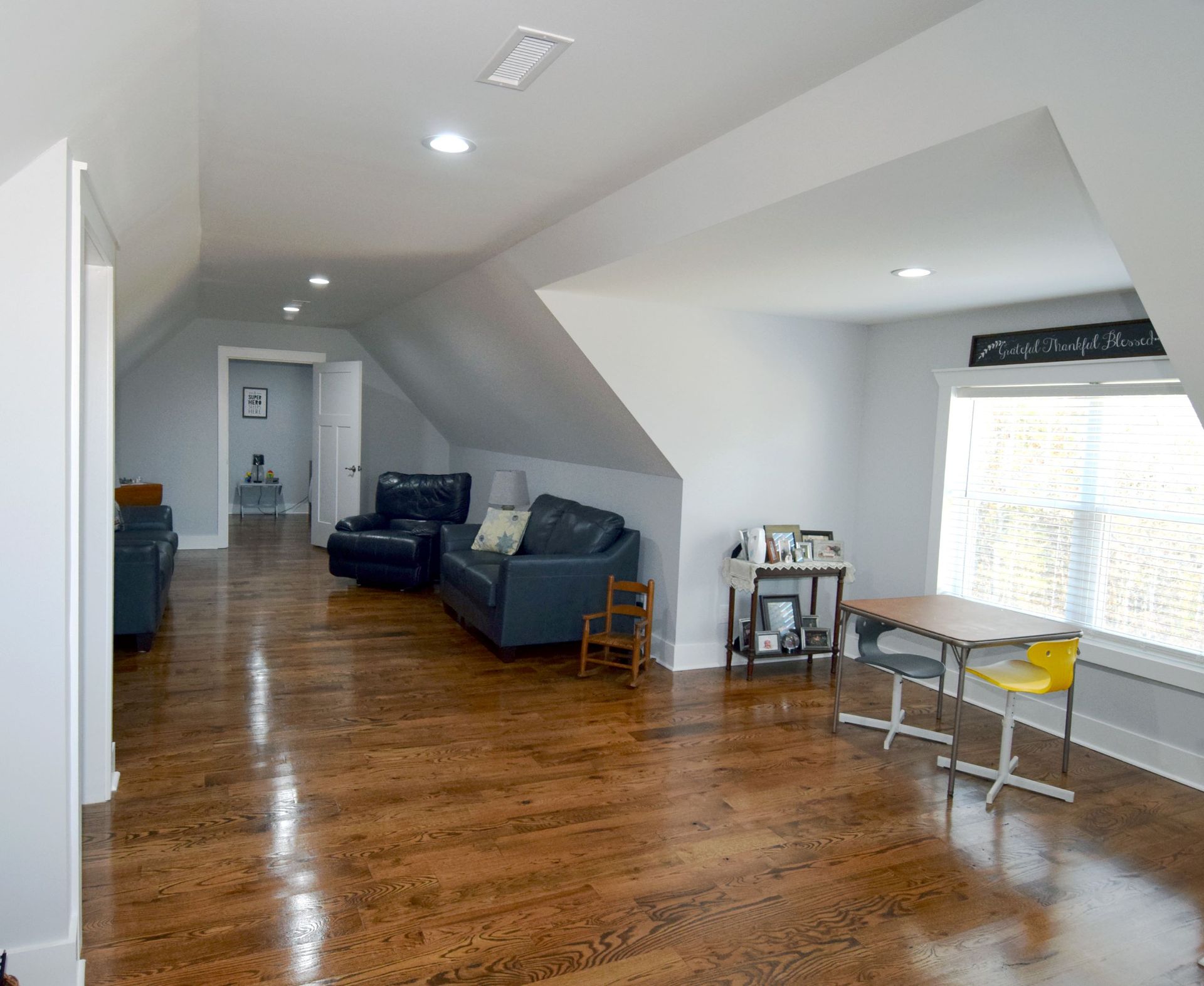 A living room with hardwood floors and a couch