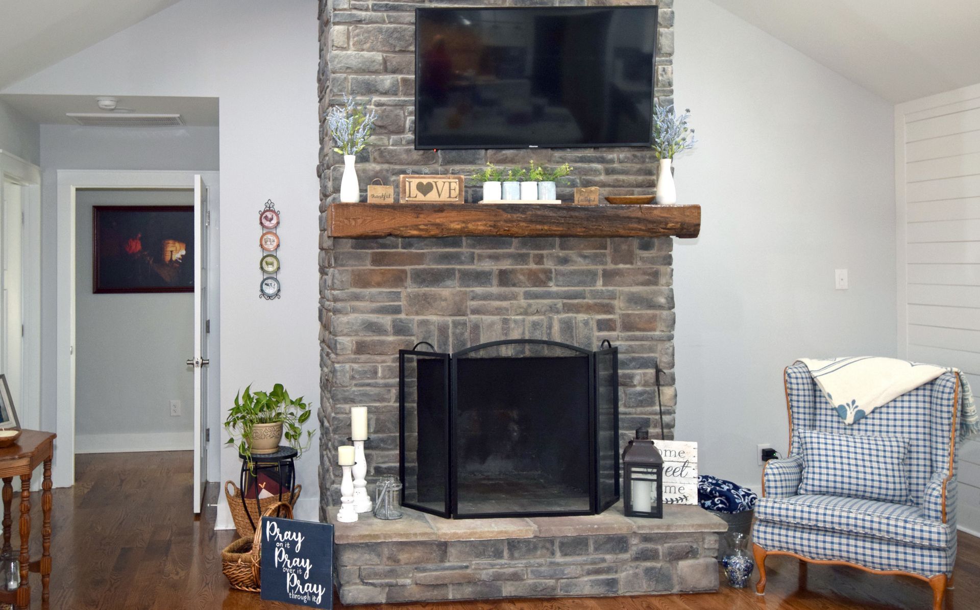 A living room with a fireplace and a flat screen tv.