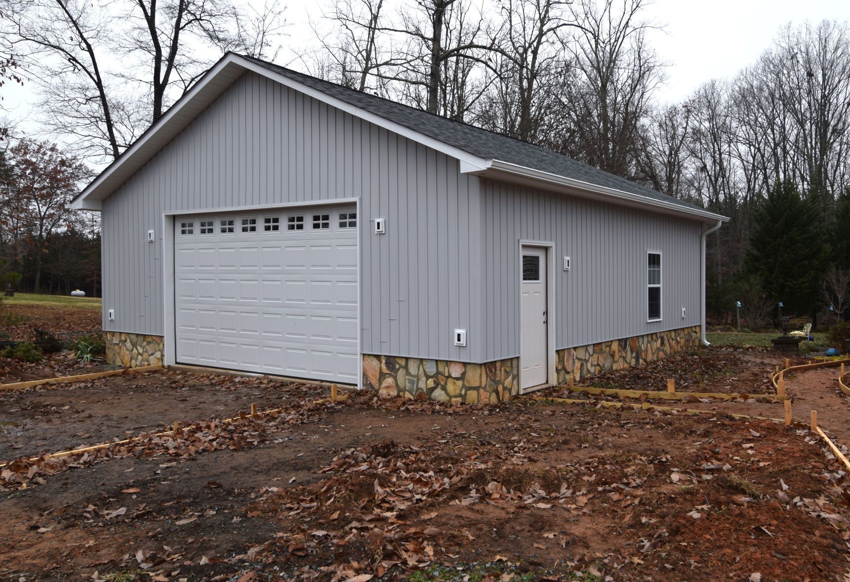 A large gray garage with a white garage door