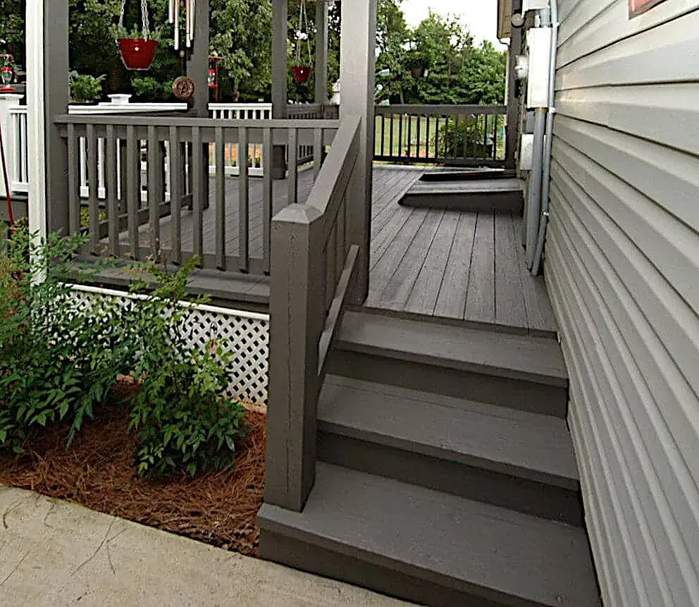 A house with a deck and stairs leading up to it
