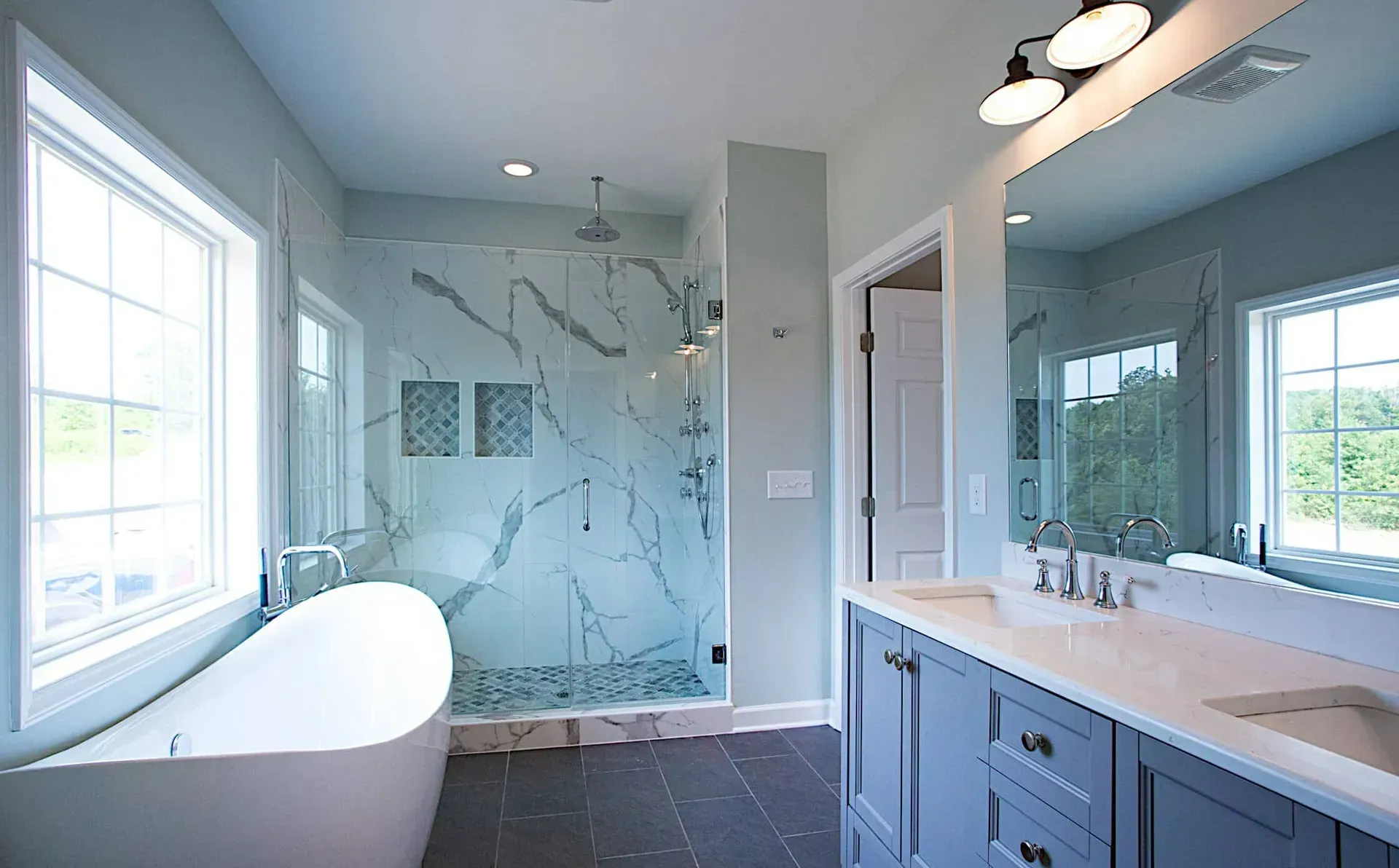 A bathroom with a tub , sink , and shower.