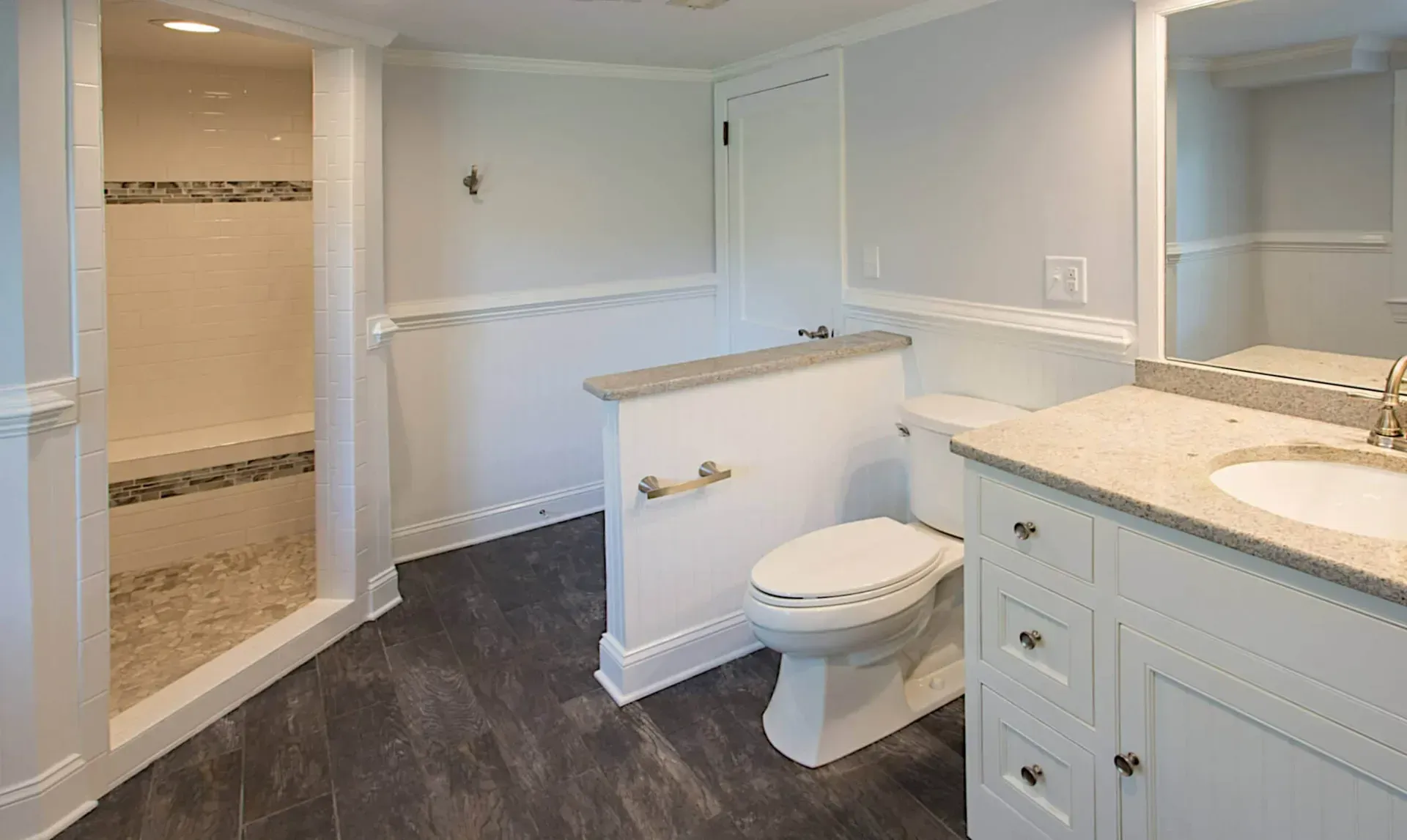 A bathroom with a toilet , sink , and shower.