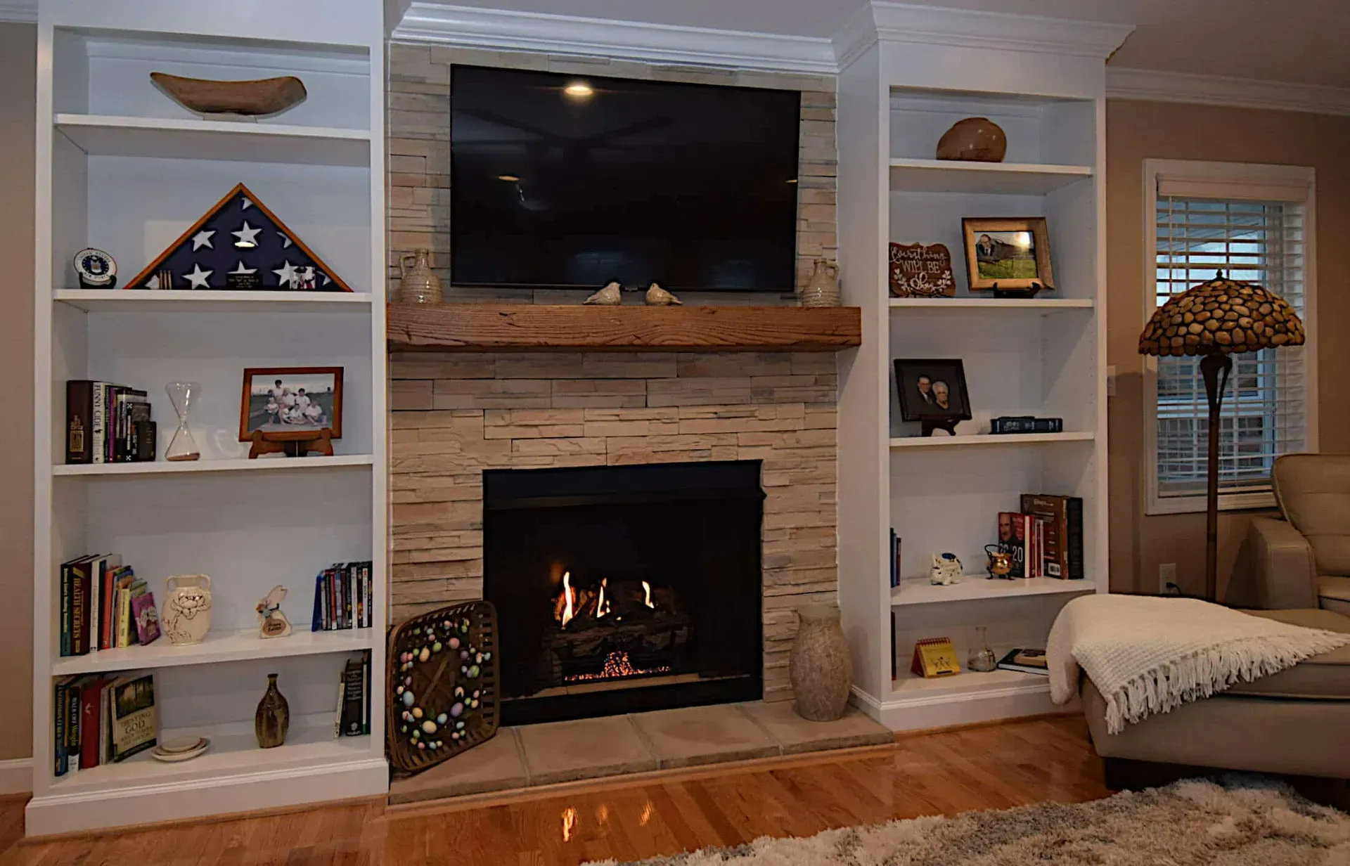 A living room with a fireplace and a flat screen tv