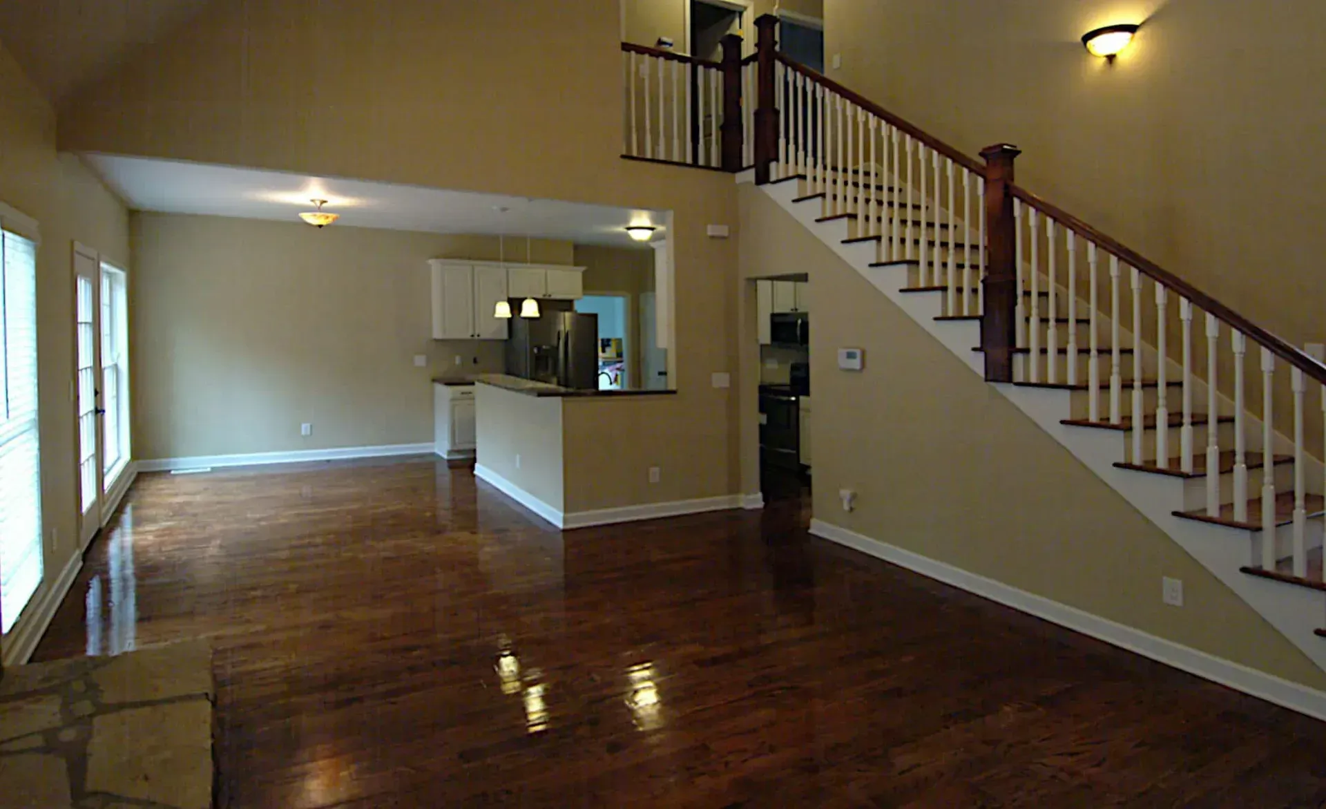 An empty house with stairs leading up to the second floor
