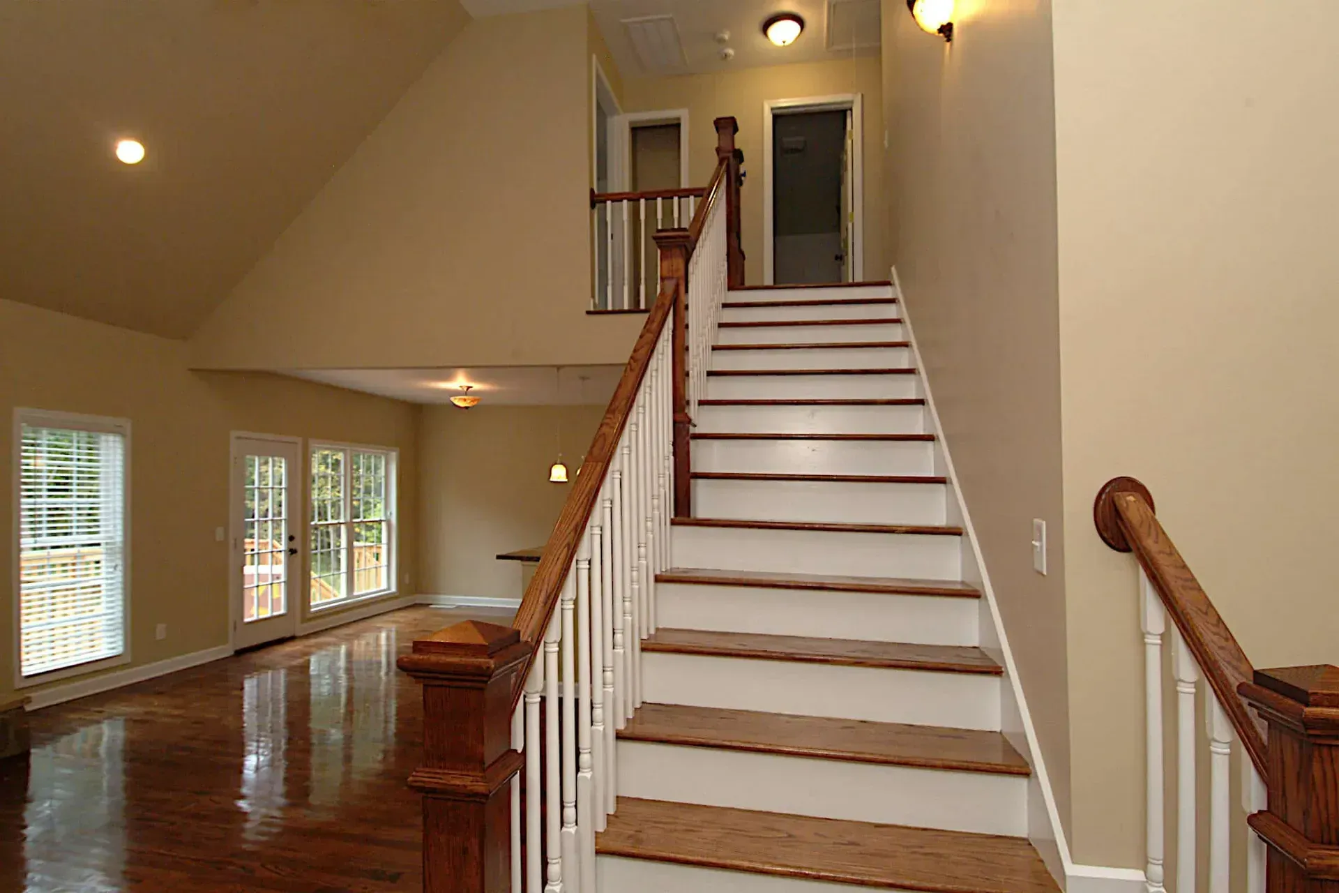 An empty house with stairs leading up to the second floor