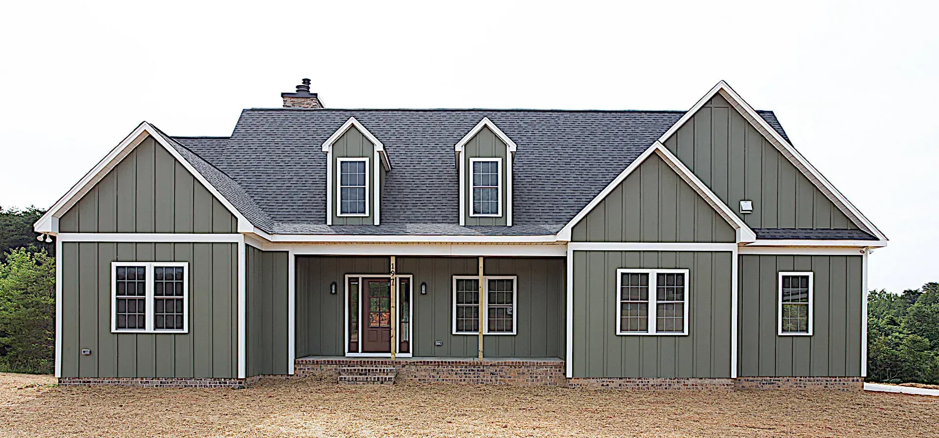 A large house with a lot of windows and a porch