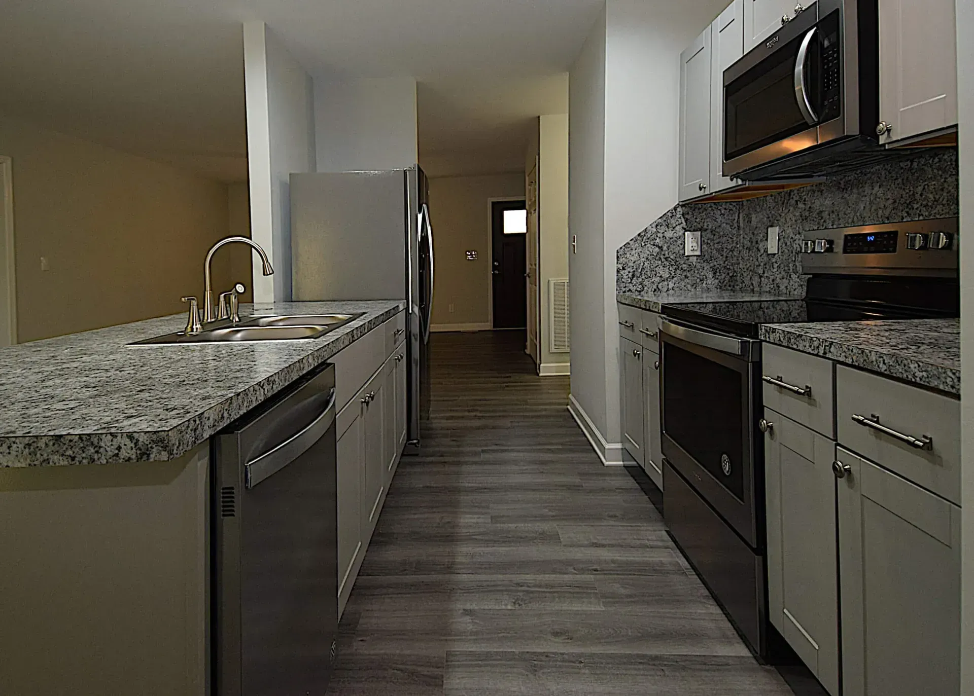 A kitchen with granite counter tops and stainless steel appliances
