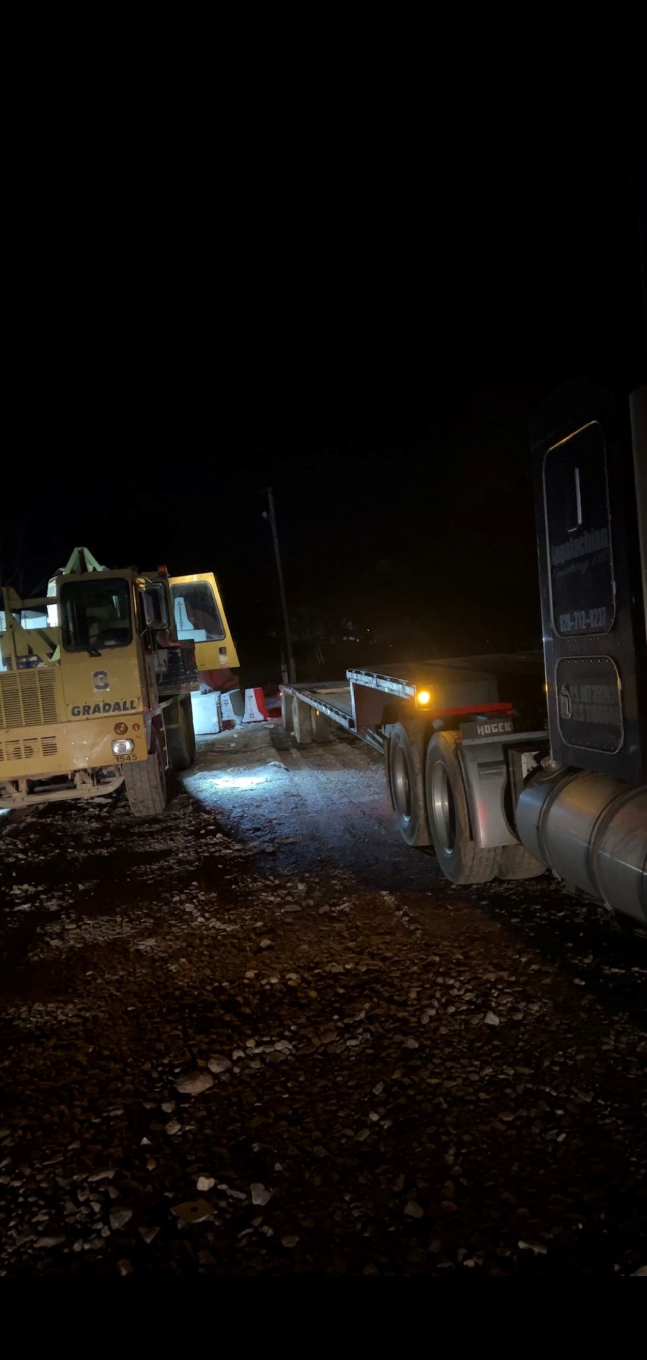 A Truck is Being Towed by a Bulldozer at Night | Weaverville, NC | Appalachian Trucking LLC