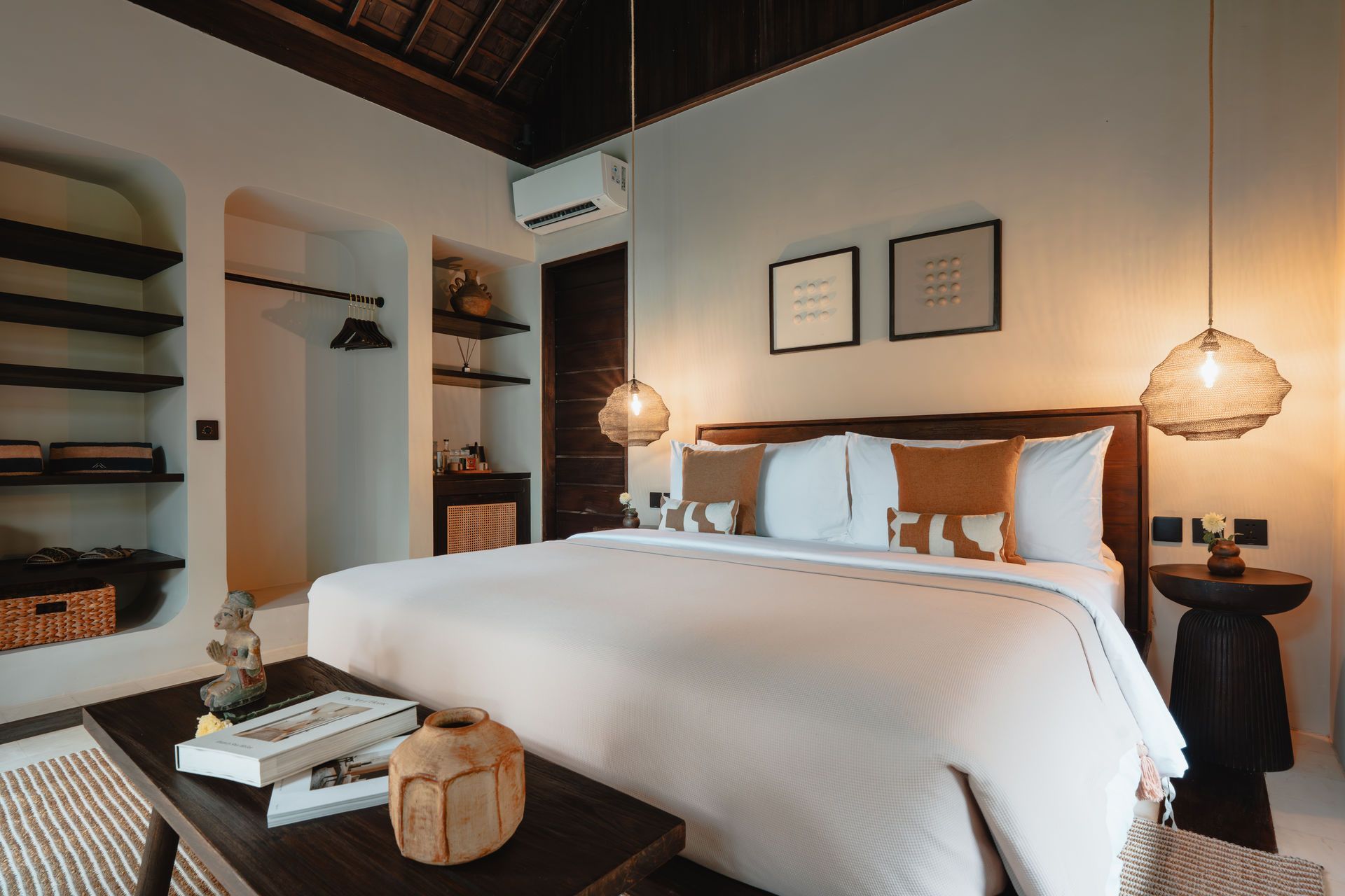 Cozy bedroom with a white bed, wooden nightstands, woven pendant lamps, and built-in shelves