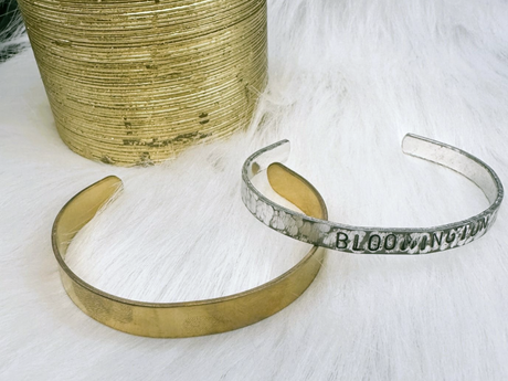 Two bracelets, one gold and one silver with