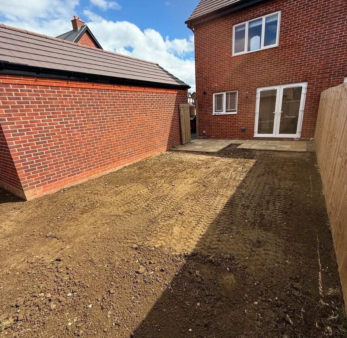 A brick house with a lot of dirt in front of it