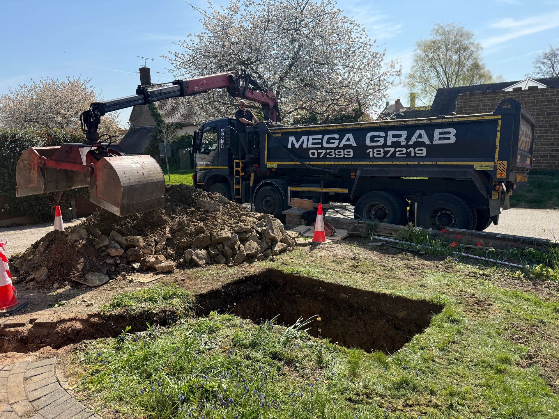 A dump truck is digging a hole in the ground.