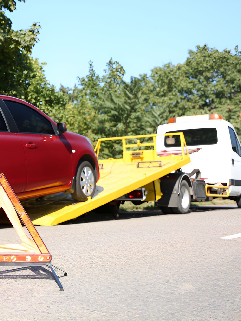 A Red Car Is Being Towed By A Tow Truck — SteelBar Restoration In Yarraman, QLD