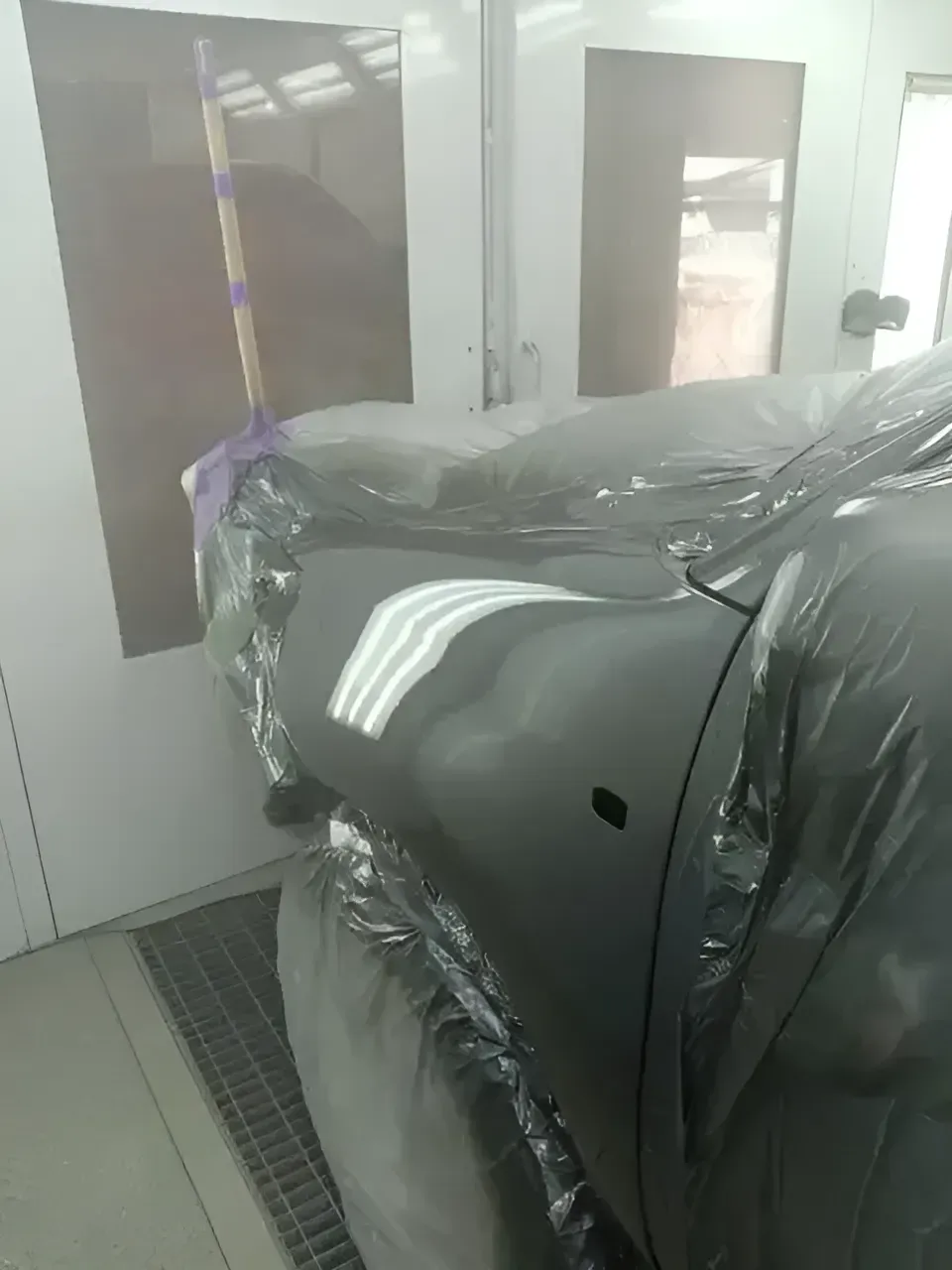 A Car Is Covered In Plastic Wrap In A Paint Booth — SteelBar Restoration In Yarraman, QLD