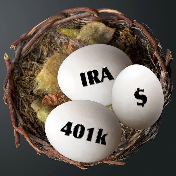 Three eggs in a nest with ira 401k and a dollar sign on them