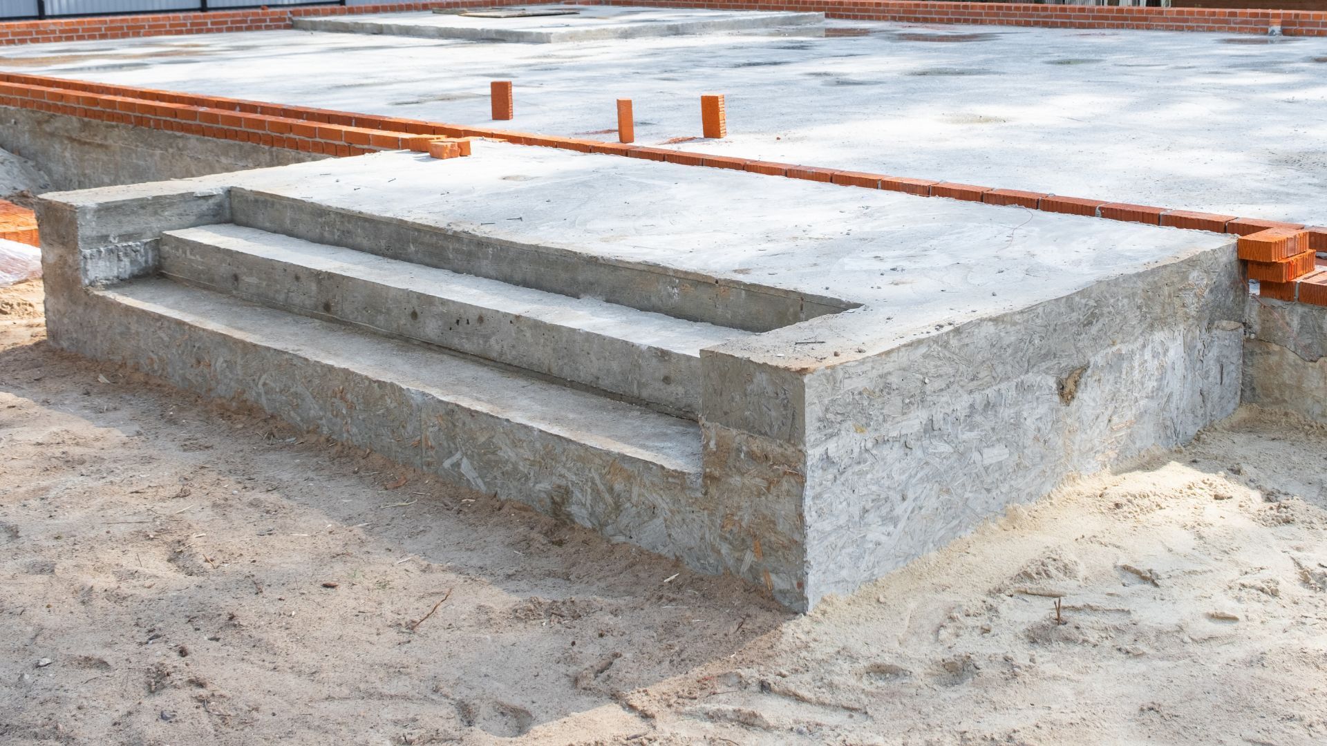 A truck is parked in a parking lot next to a concrete platform.