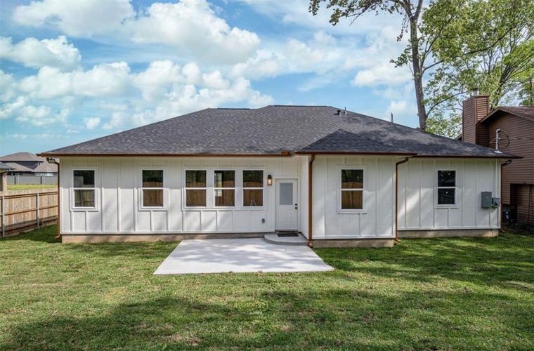 A man is standing on the side of a road.