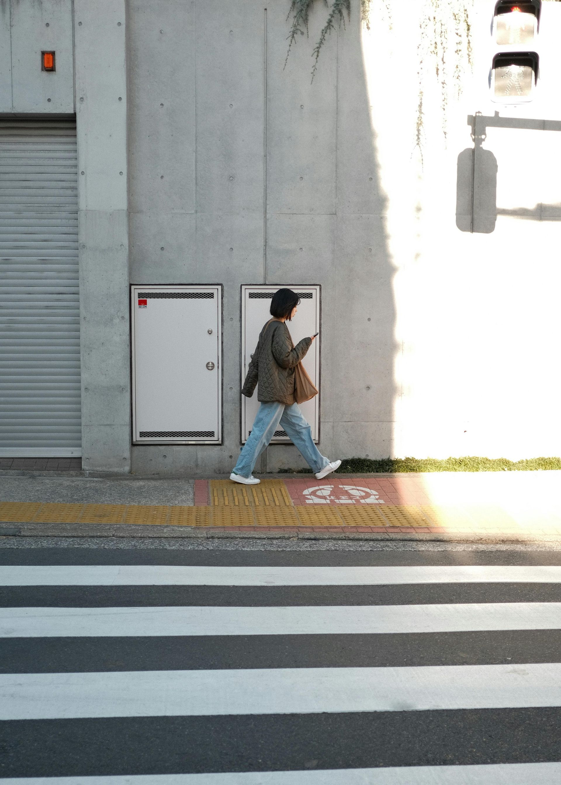 A shadow of a person taking a picture of a road