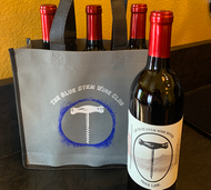 the Blue Stem wine club tote with three bottles of wine included in it. bottle of wine next to tote.