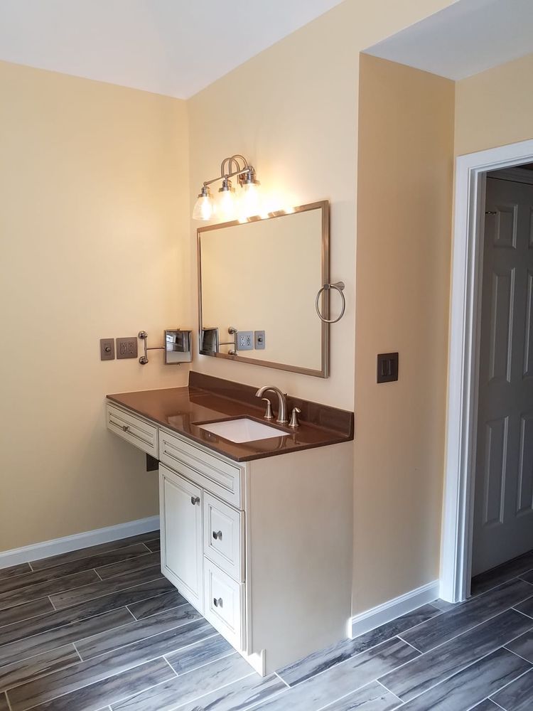 Bathroom with a lowered vanity, mirror, and accessible features.