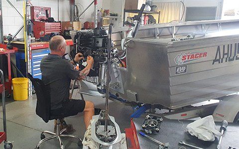 HiTune Marine Staff Repairing Marine Outboard Engine — Boat Servicing & Repairs In Cairns, QLD