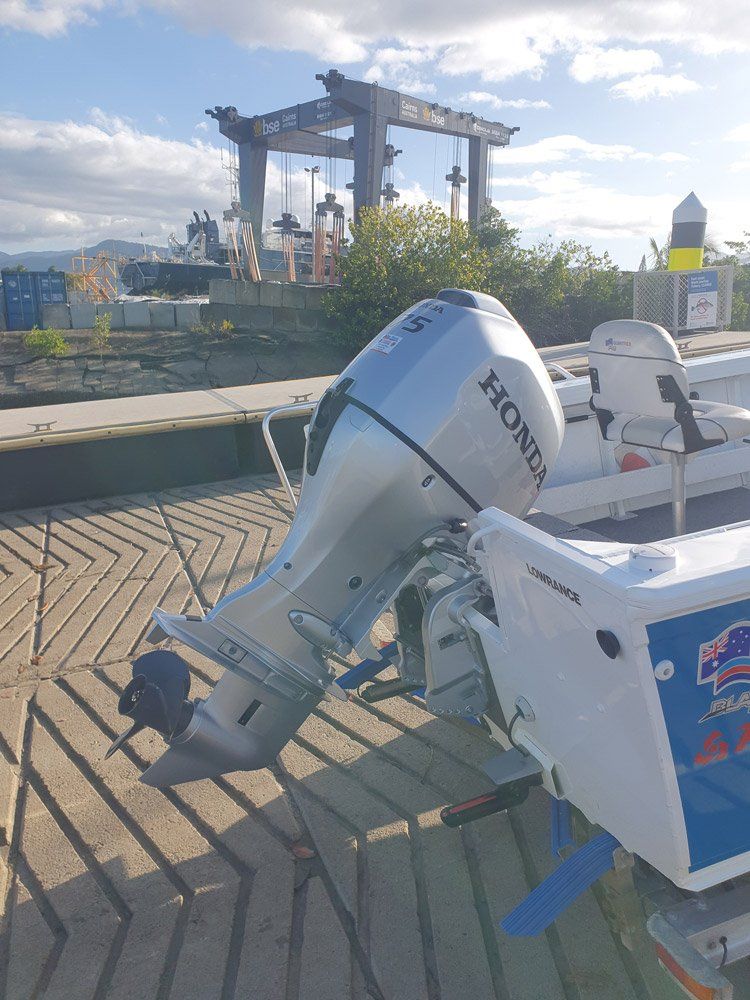 A Boat With A Honda Outboard Motor Is Parked On A Dock — HiTune Marine In Bentley Park, QLD